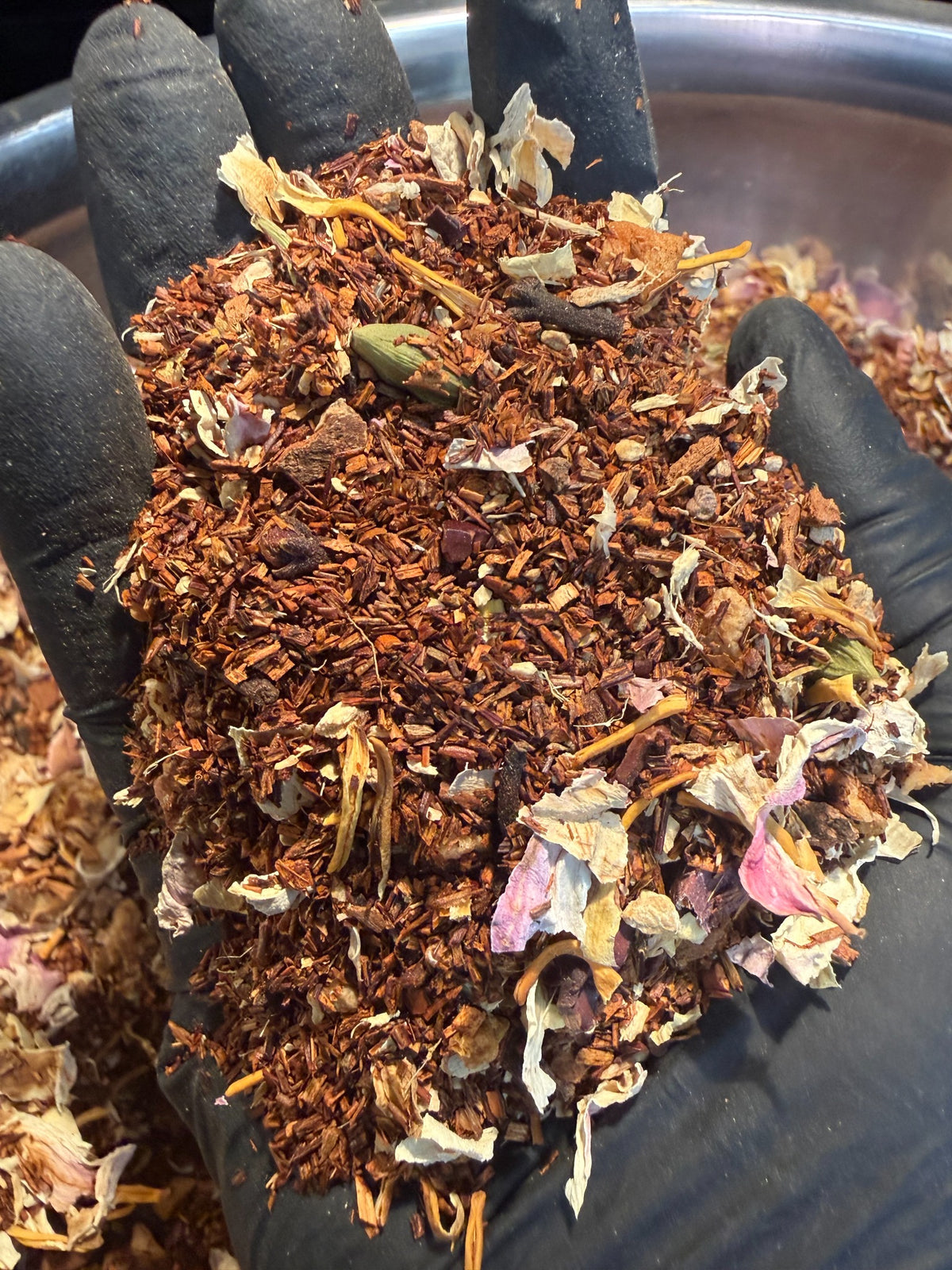 Close-up of Sacred Grounds rooibos tea blend with spices petals and roots