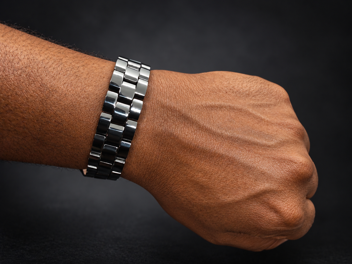 Black linked magnetic bracelet worn on a masculine wrist